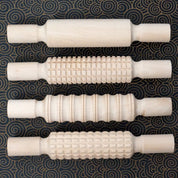 Wooden Patterned Rolling Pins on clay creating textured art designs