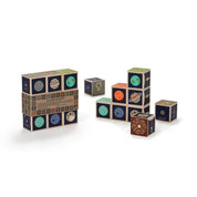Planet Blocks by Uncle Goose showing planet symbols, names, moons, illustrations, and distances from the sun for educational play