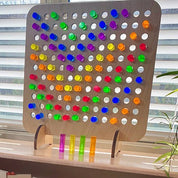 Birch wood pegboard with colorful, translucent acrylic pegs for sensory play and pattern building on a wooden stand.