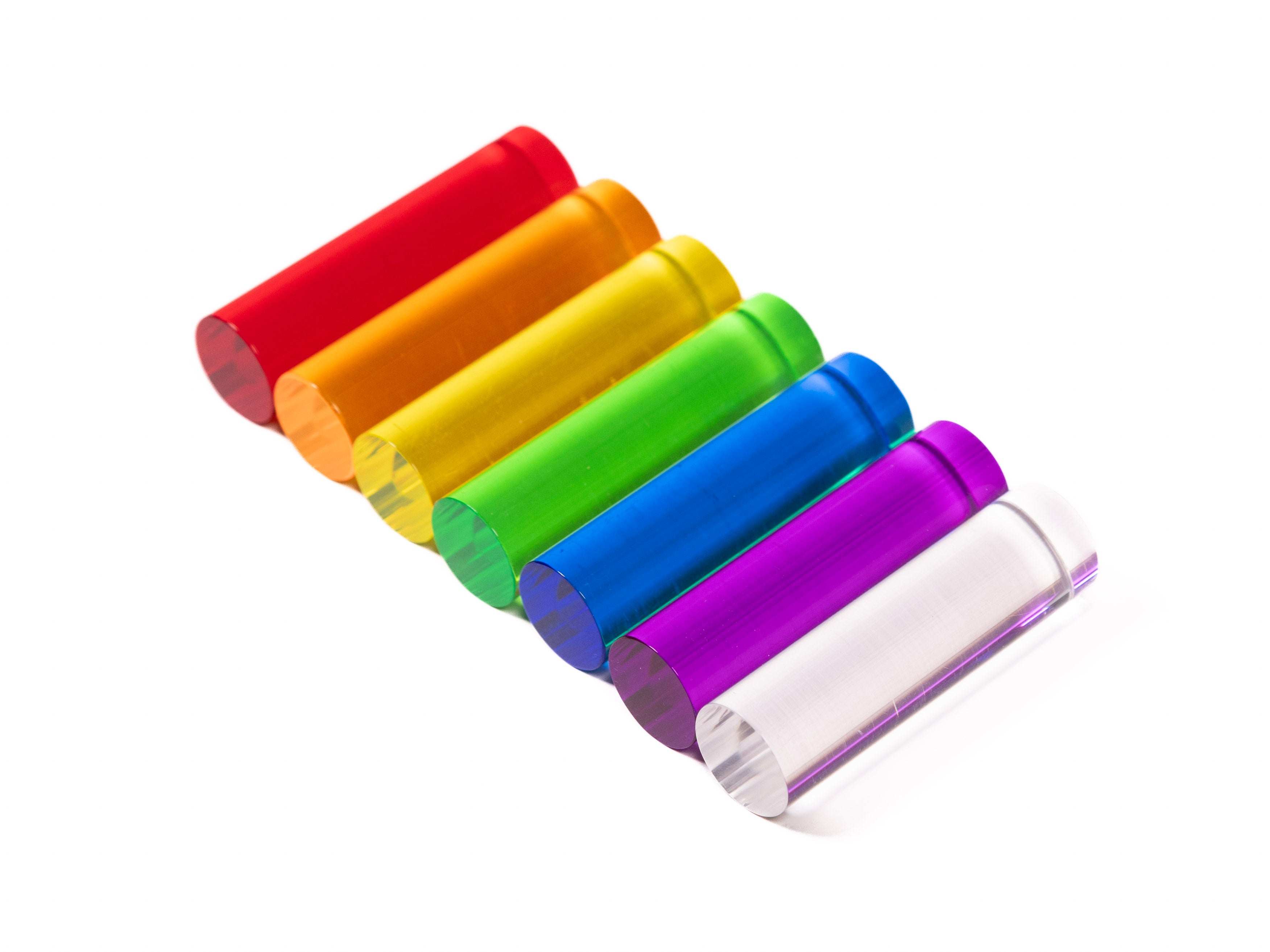 Translucent acrylic rainbow pegs in seven colors arranged for light exploration and construction