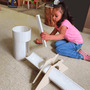 Children playing with Kodo Ramp Starter Set featuring ramps, balls, stands, and tunnel for creative exploration