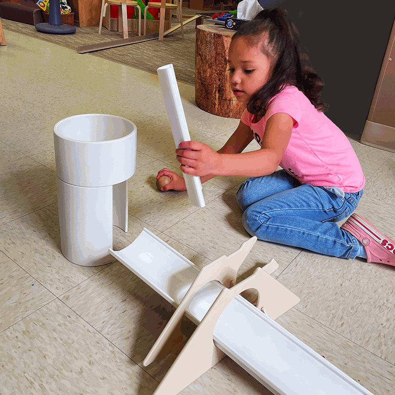 Children playing with Kodo Ramp Starter Set featuring ramps, balls, stands, and tunnel for creative exploration