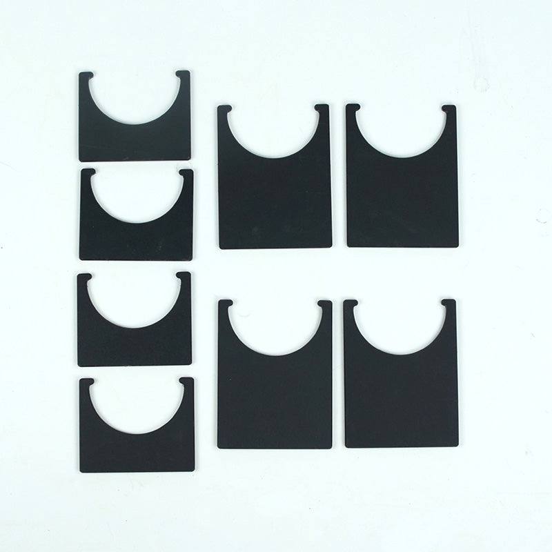 Set of black, flat-panel fulcrum feet with U-shaped cutouts for connecting ramps in a STEM obstacle course.