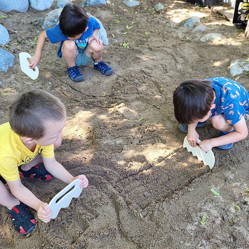 Children playing with Sand Shapers tools in a playground sandbox exploring sand textures and shapes