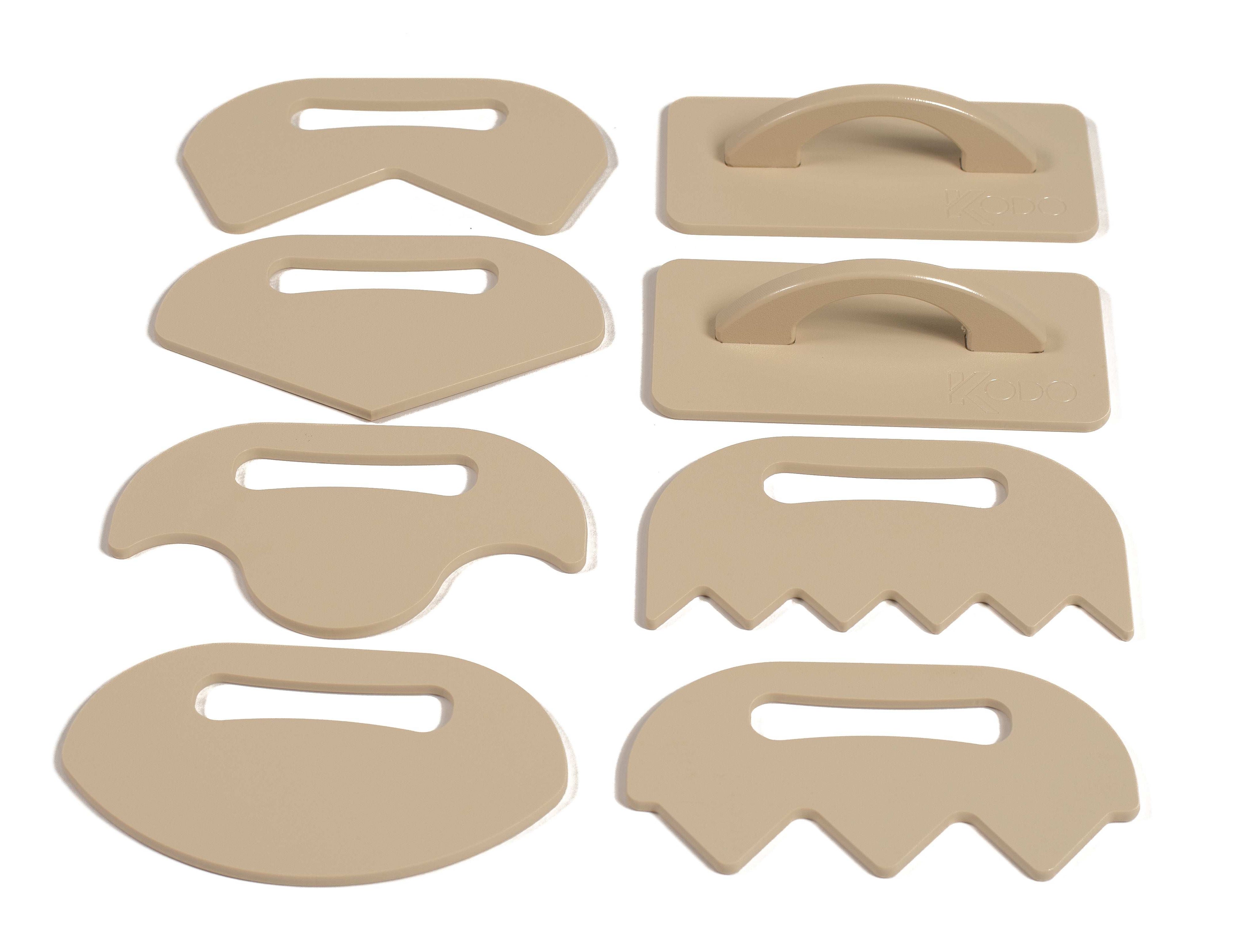 Eight-piece tan plastic sand shaping tool set with various edges for scooping, smoothing, and raking sand.