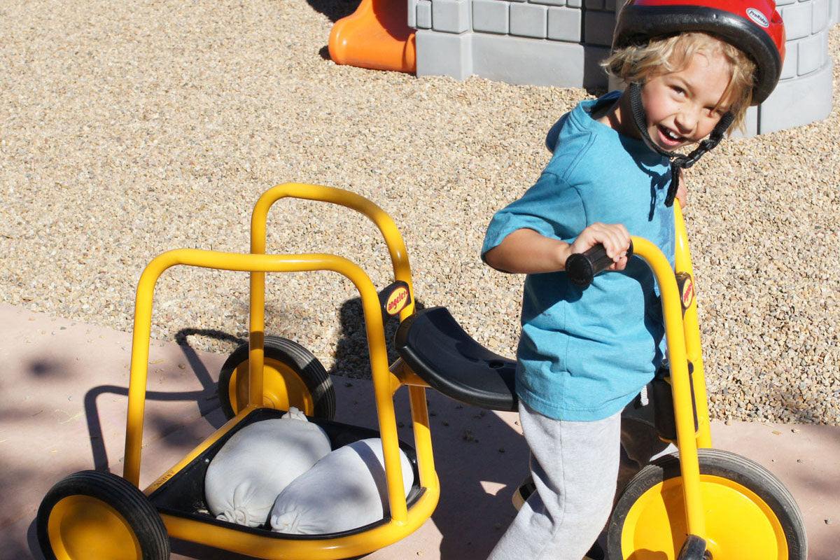 Children building creatively with flexible white sandbags in classroom play area