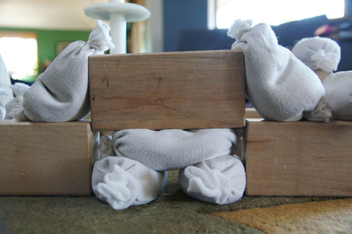 Children playing and building with flexible sandbags in a classroom setting