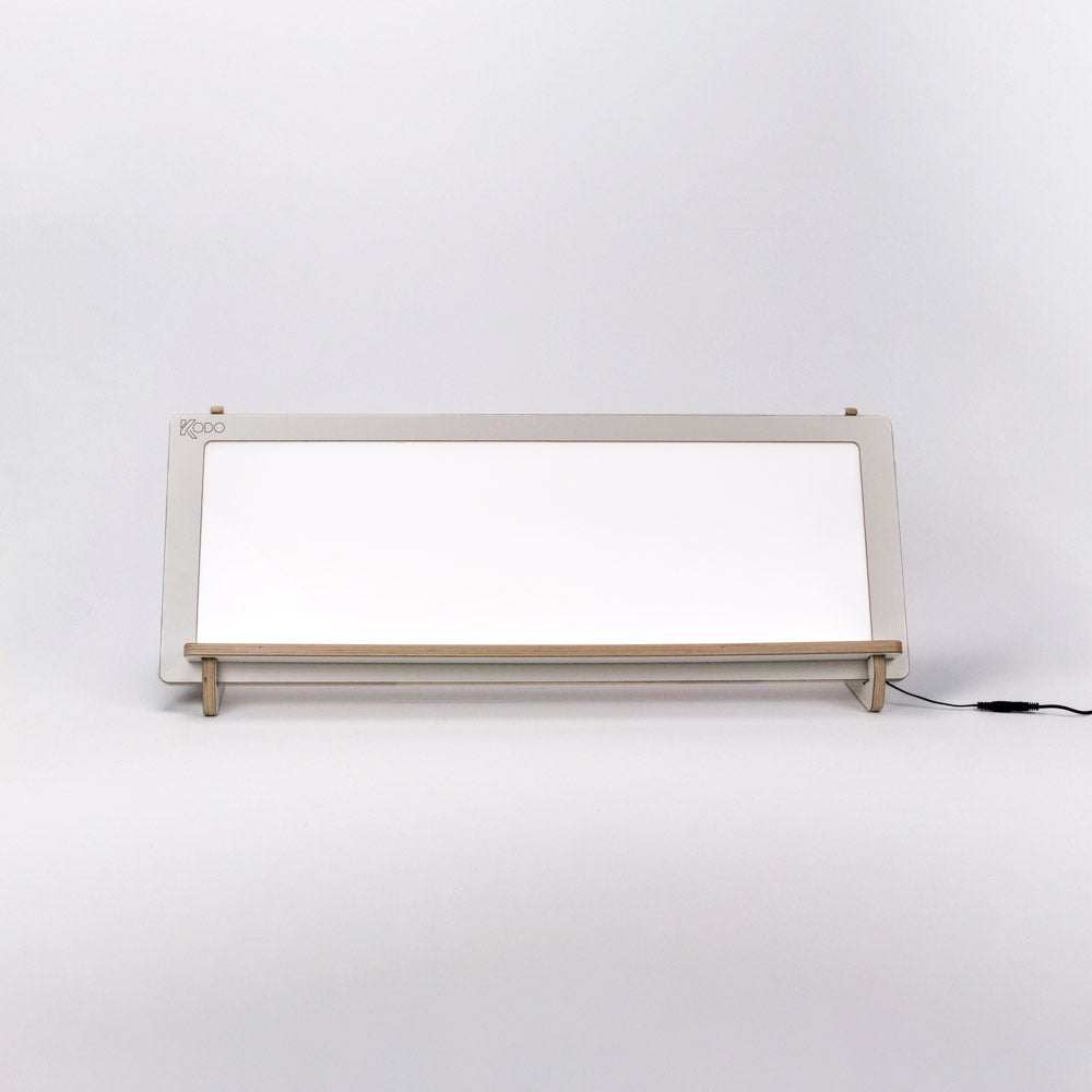 Rectangular LED light panel with a light wood frame and integrated shelf, designed for classroom tabletop or shelf use.
