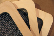 Three light wood frames with metal mesh screens of varying sizes for sorting and classifying sensory materials.