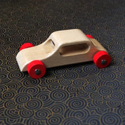 Set of handcrafted wooden cars made from solid hardwood with steel axles and natural lacquer finish