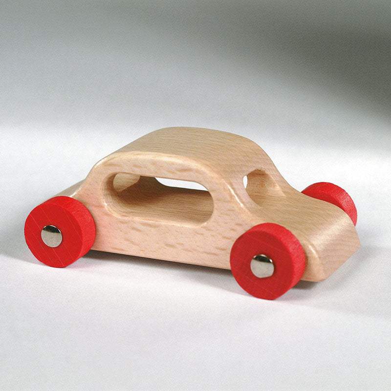 Wooden Cars made of solid hardwood with steel axles on a pathway