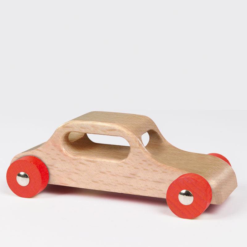 Wooden cars made of solid hardwood with steel axles and natural lacquer on a ramp
