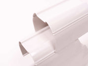 Two interlocking white plastic stacking tunnels for children's STEM play and marble run construction.