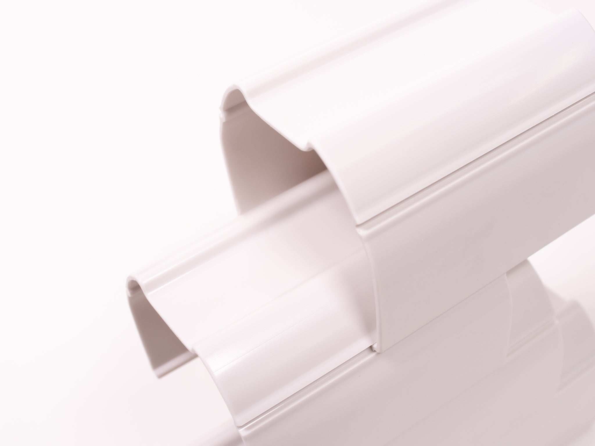 Two interlocking white plastic stacking tunnels for children's STEM play and marble run construction.