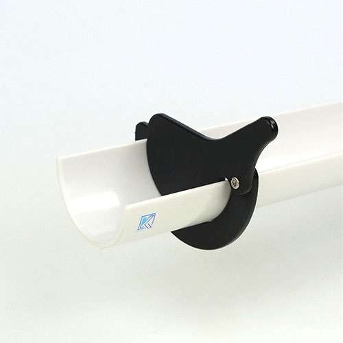 Black plastic Stop and Go gate clipped onto a white Kodo ramp for controlling toy movement.