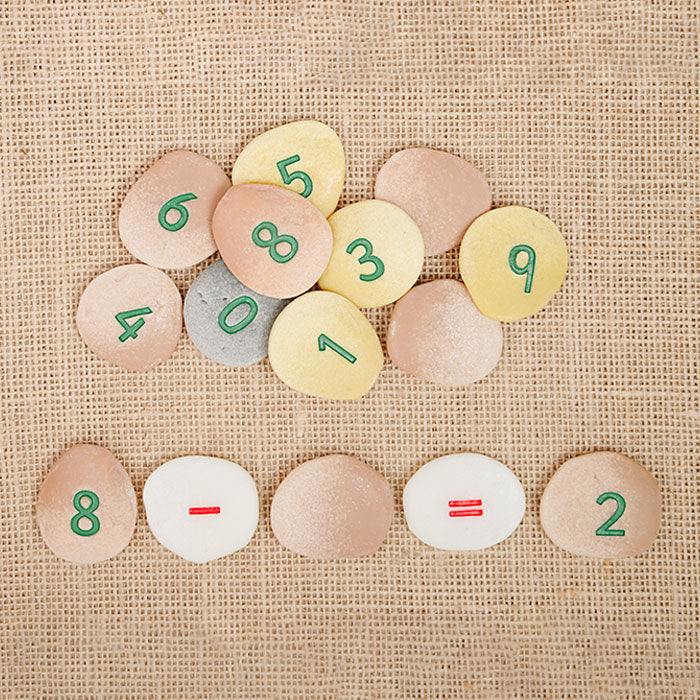 Colorful durable number pebbles with numerals and symbols for educational math play