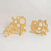 Swiss cheese-inspired wooden ramp stands with circular cutouts for STEM building and physics exploration.