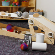 Set of 20 assorted silver and white metal tins used for creative play with wooden ramps and felt balls.