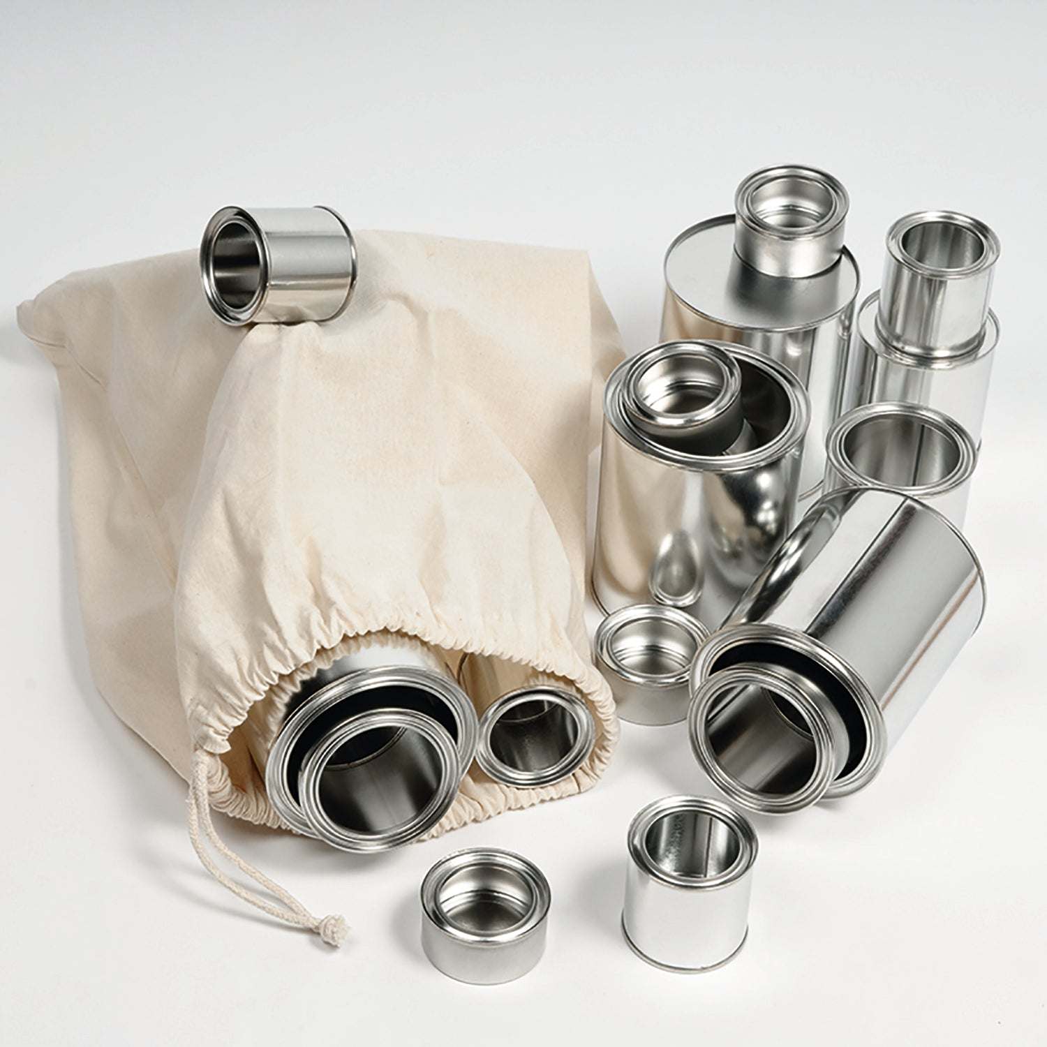 Set of 20 shiny silver metal tins in four sizes, displayed with a natural cotton drawstring storage bag.
