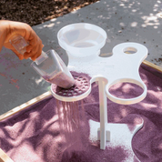 Toddler playing with colorful Toddler Funnel Stand in sensory table enhancing motor skills and STEAM learning