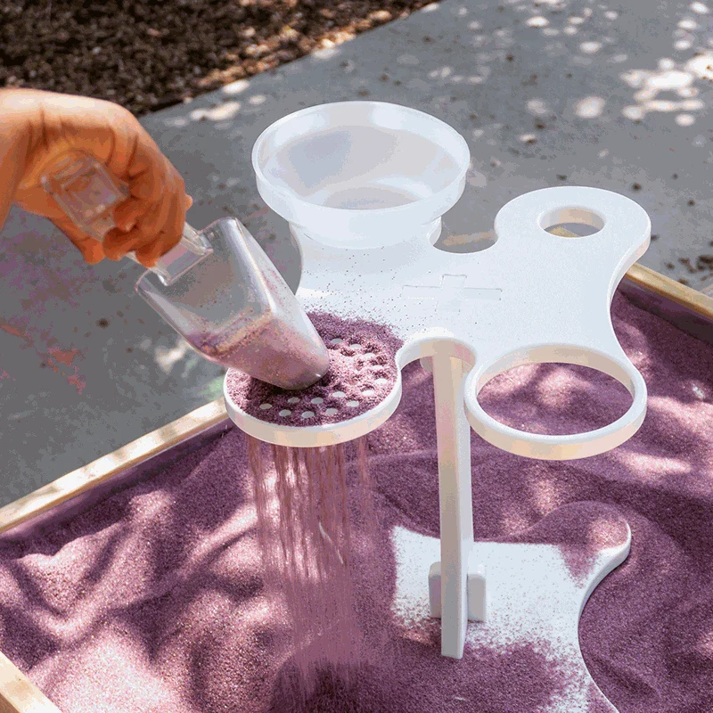 Toddler playing with colorful Toddler Funnel Stand in sensory table enhancing motor skills and STEAM learning