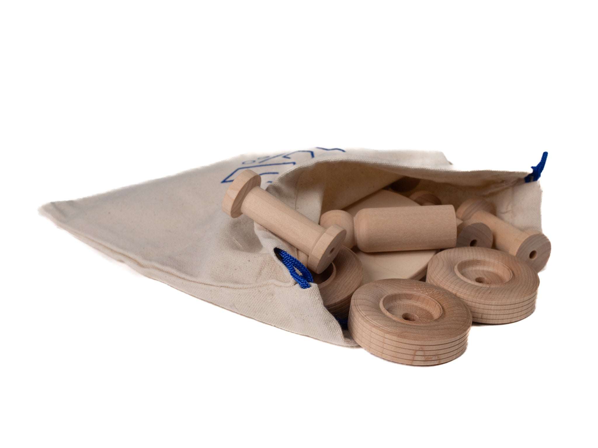 Natural wooden building blocks, wheels, and spools spilling out of a beige canvas drawstring storage bag.