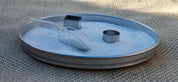 Milky white translucent sensory beads in a metal tray with a clear plastic scoop and two metal shape molds.