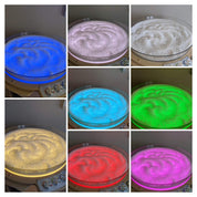 Milky white translucent sensory beads glowing in various colors on a circular light panel tray.