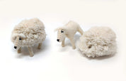 Handmade felt sheep toy with a removable woolly coat next to a shorn sheep figure on a white background.