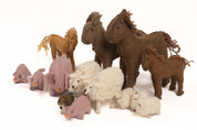 Set of 14 handmade felt farm animal figures, including brown horses, pink pigs, and white woolly sheep on a white background.