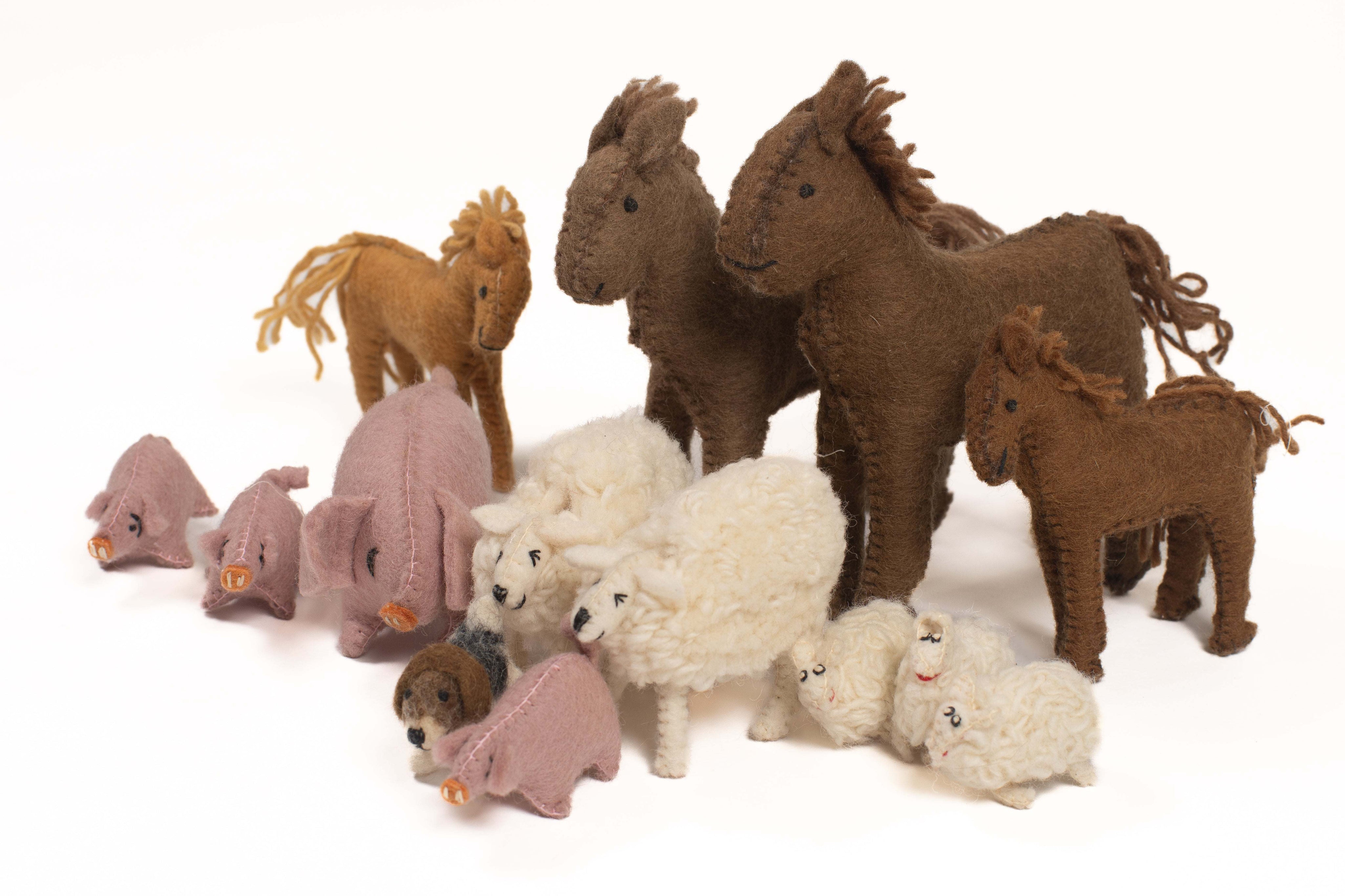 Set of 14 handmade felt farm animal figures, including brown horses, pink pigs, and white woolly sheep on a white background.