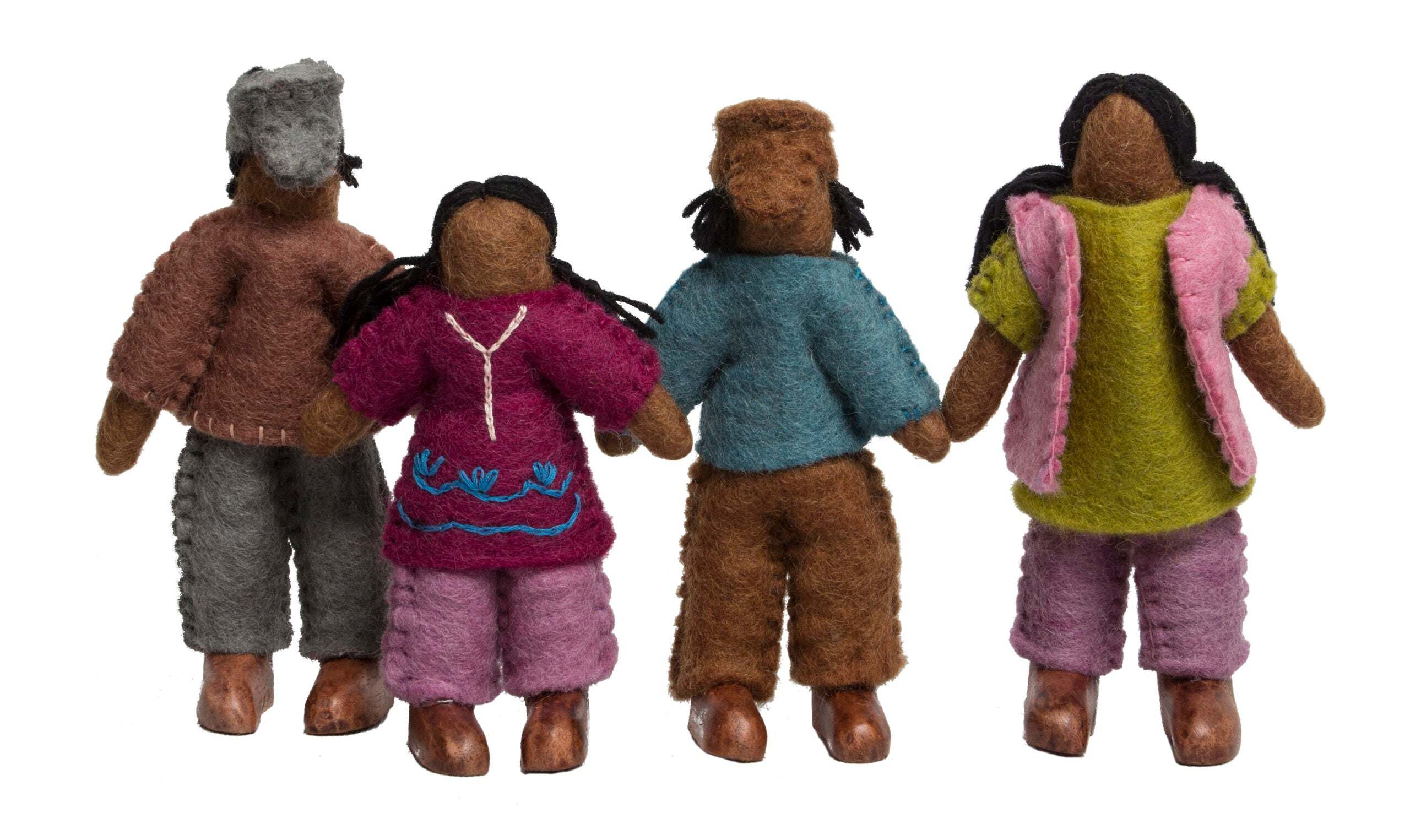 Four handcrafted felt wool dolls with diverse clothing and wooden feet standing in a row.