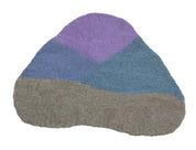 Irregularly shaped wool playscape mat featuring layered sections of purple, blue, and grey felt for sensory play.