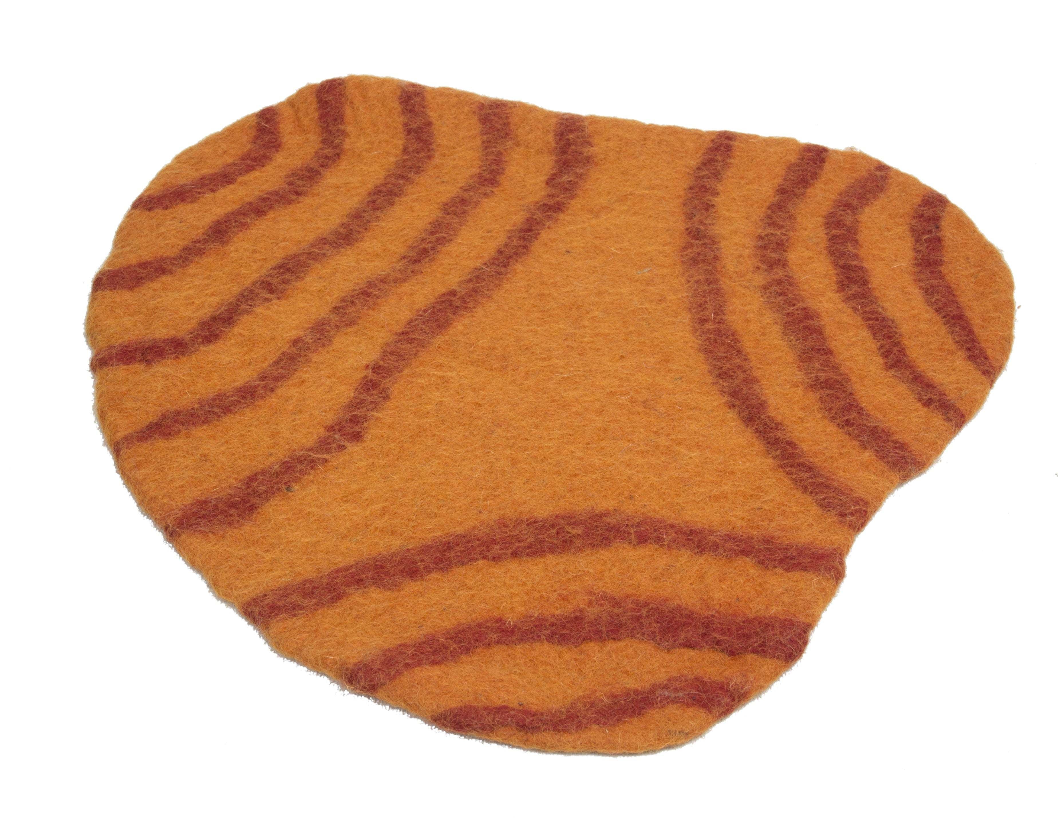 Irregularly shaped orange wool playscape mat with textured dark red concentric line patterns for sensory play.