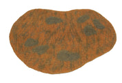 Irregularly shaped orange and brown felted wool playscape mat with dark textured sensory spots for children.