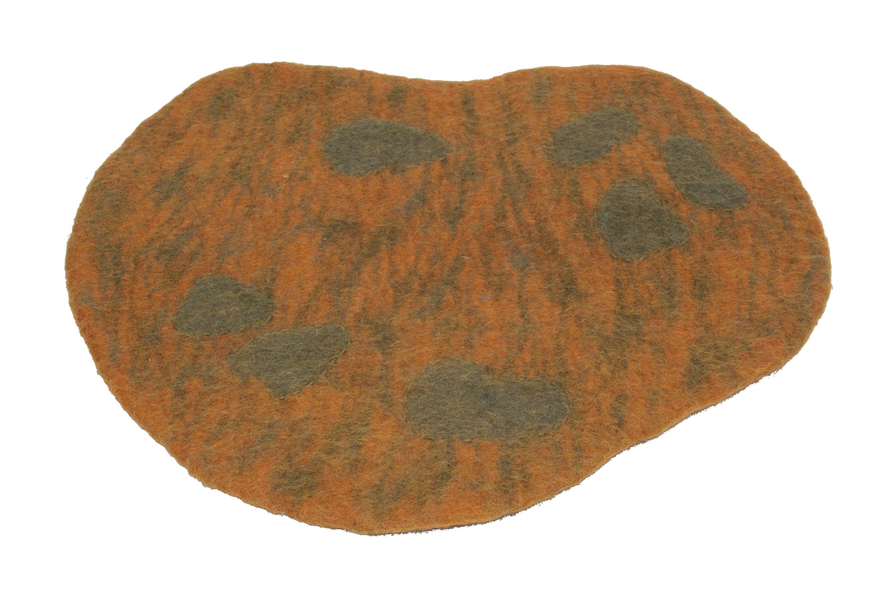 Irregularly shaped orange and brown felted wool playscape mat with dark textured sensory spots for children.