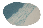 Oval felted wool playscape mat in white and blue, featuring a textured, marbled design for sensory play.