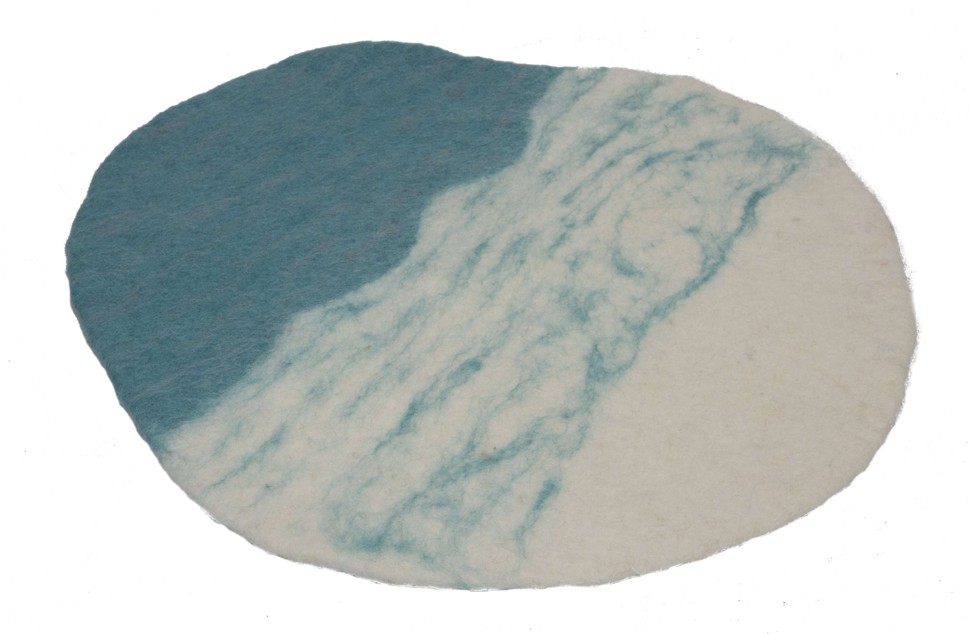Oval felted wool playscape mat in white and blue, featuring a textured, marbled design for sensory play.